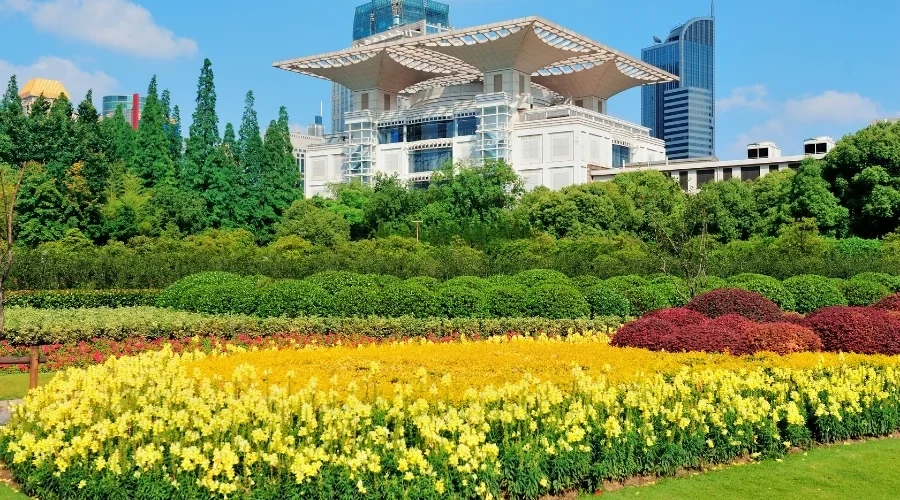 Flower beds and maintained grounds beside a large property