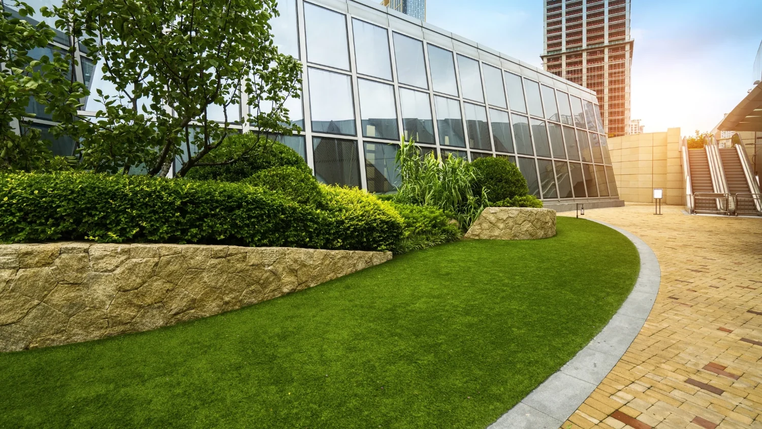 Maintained lawn and rock borders beside an office entrance