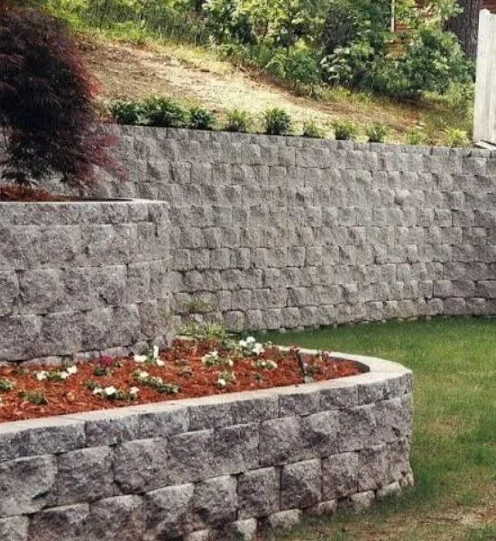 Textured retaining wall beside a lower planting bed