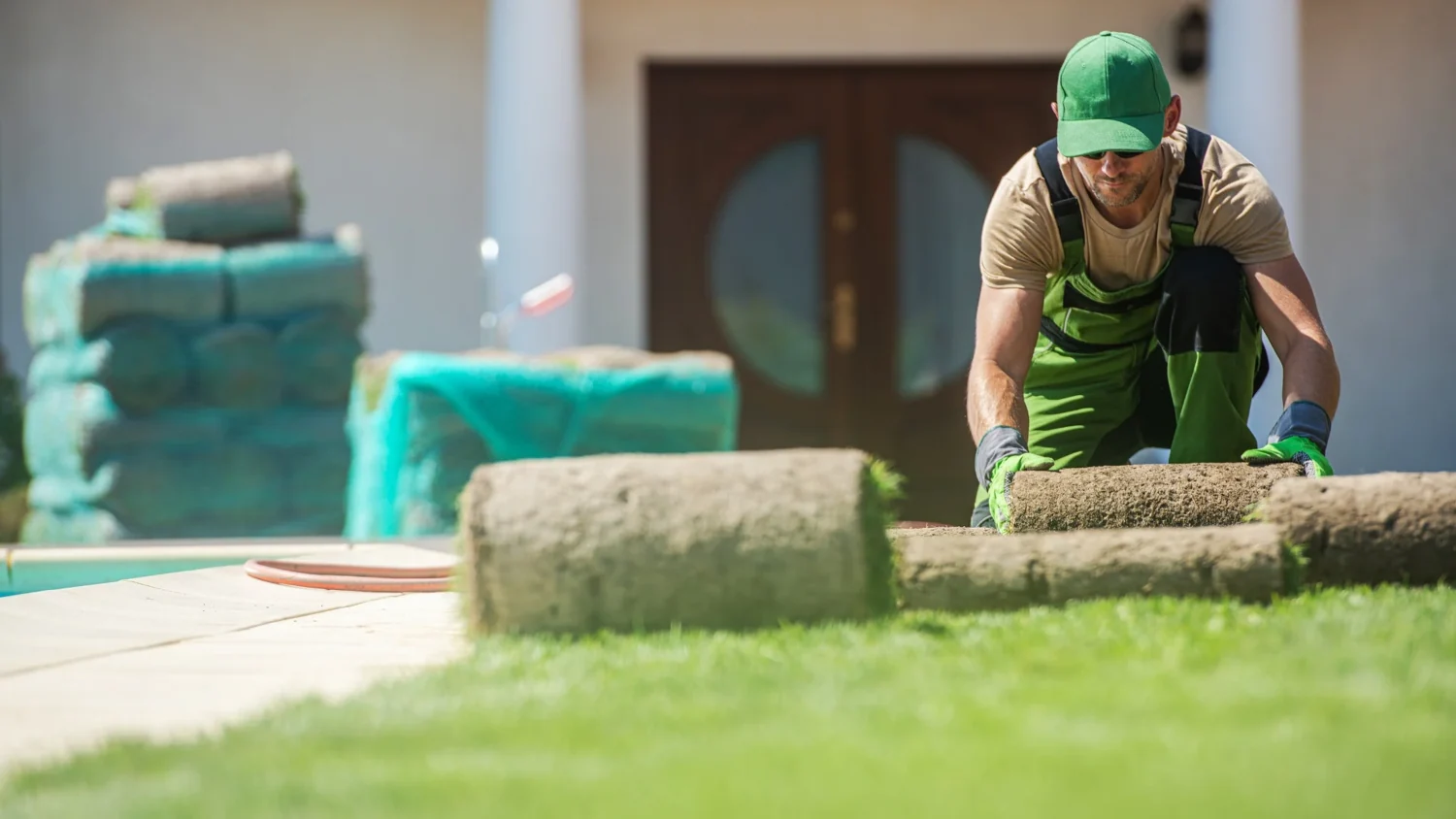 Installer laying rolled sod for a new lawn