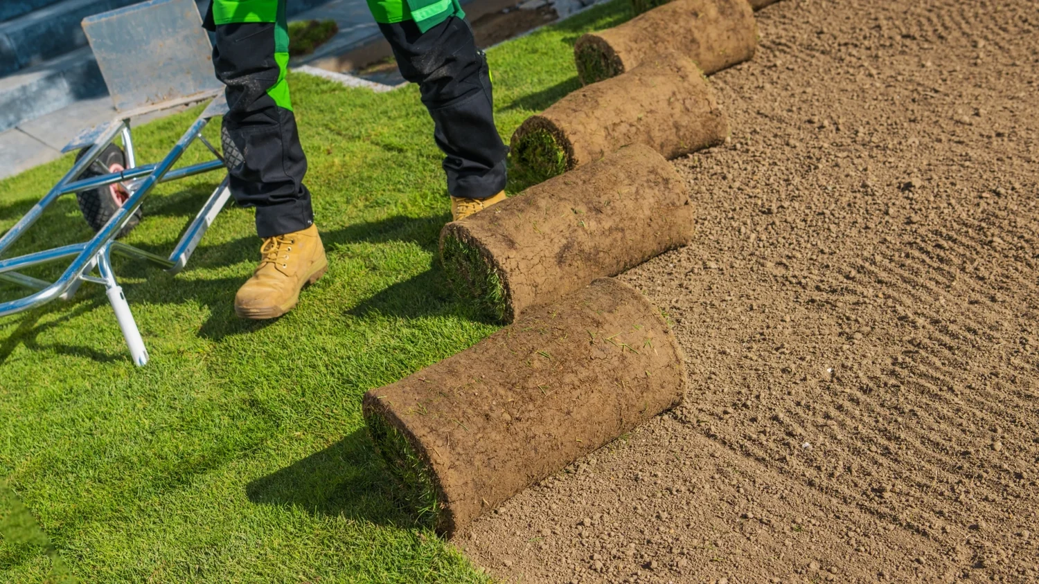 Sod installer working along a new lawn edge